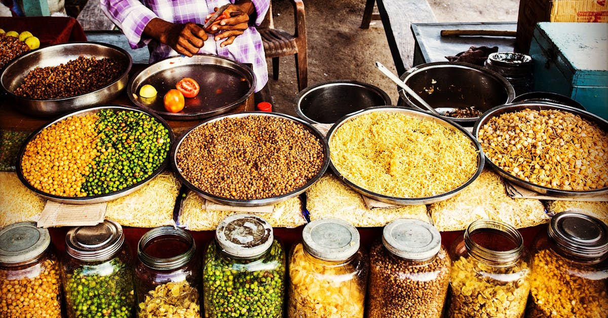 Colorful display of spices and legumes in a traditional Indian street market.